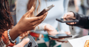 Group of people using smartphones for social media engagement — representing ClickIt Digital’s social media marketing strategies that help Kansas City small businesses connect, grow, and build loyal audiences.