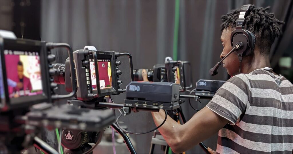 Video production specialist managing multiple camera setups during a professional brand shoot for a Kansas City business