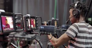 Video production specialist managing multiple camera setups during a professional brand shoot for a Kansas City business