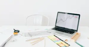 Laptop with analytics chart and business reports on desk representing SEO tracking and digital marketing performance