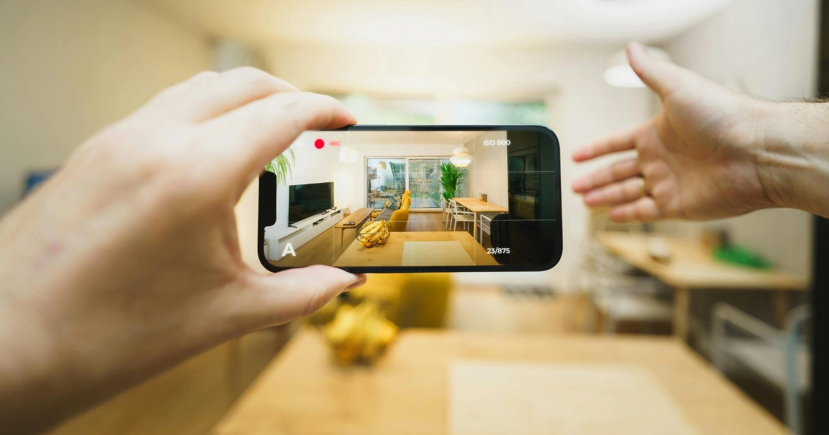 Person filming a bright modern space with a smartphone — representing ClickIt Digital’s professional video marketing and production services that help Las Vegas businesses boost visibility and brand engagement.