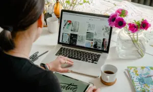 Designer reviewing visual web layouts on a laptop, representing how regional design trends influence user experience for Las Vegas businesses