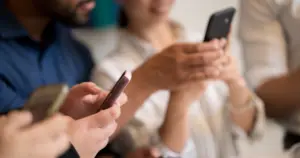 People using smartphones to compare paid vs organic social media strategies for business marketing and audience engagement